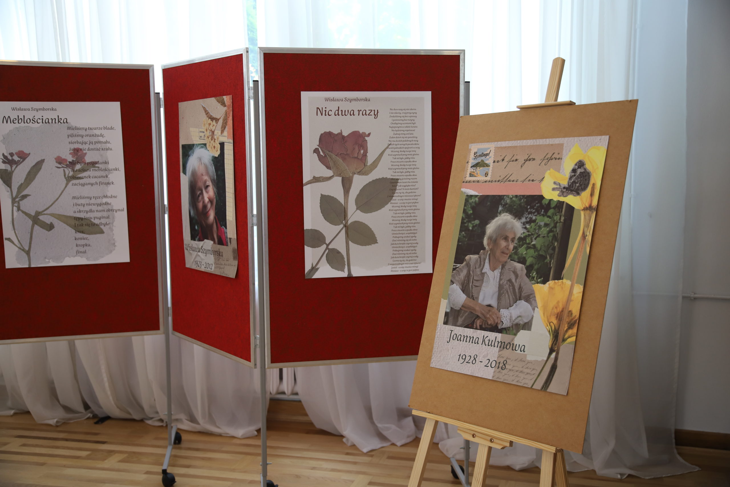 grafika przedstawiająca cztery plansze. Jedna przedstawia wizerunek Joanny Kulmowej, druga Wisławy Szymborskiej. Dwie pozostałe przedstawiają wiersze Wisławy Szymborskiej pt. "Nic dwa razy" i "Meblościanka"