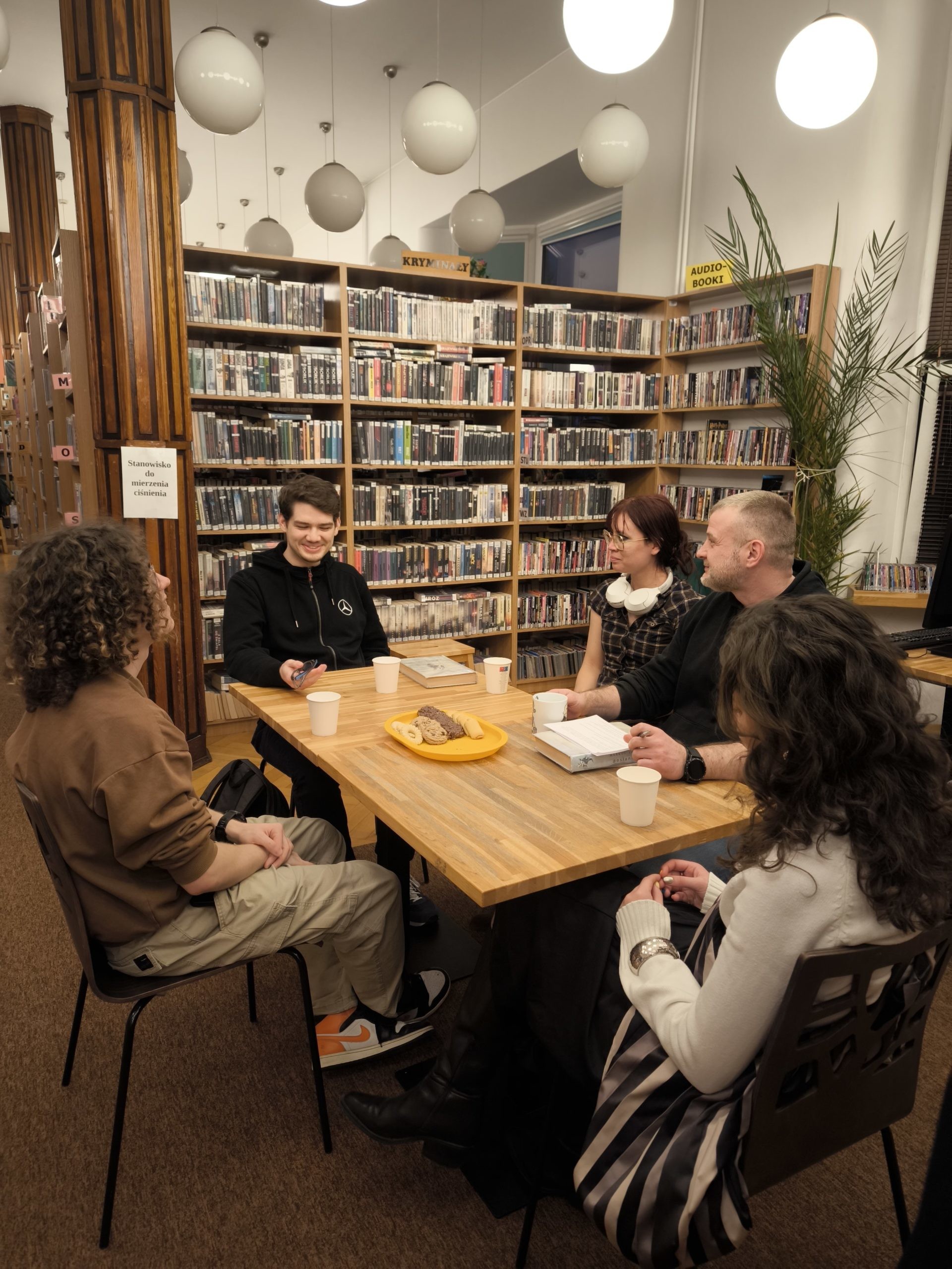 grafika przedstawiająca uczestników młodzieżowego dyskusyjnego klubu książki podczas omawiania książki "Posłaniec" Markusa Zusaka